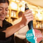 A,Young,Woman,Working,Behind,A,Bar,Preparing,Drinks